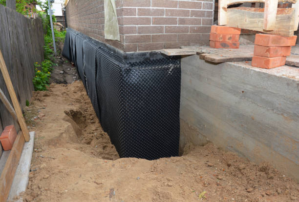 SJ Waterproofing Pros technician performing targeted Wet Basement Repair assessment in New Carlisle, OH